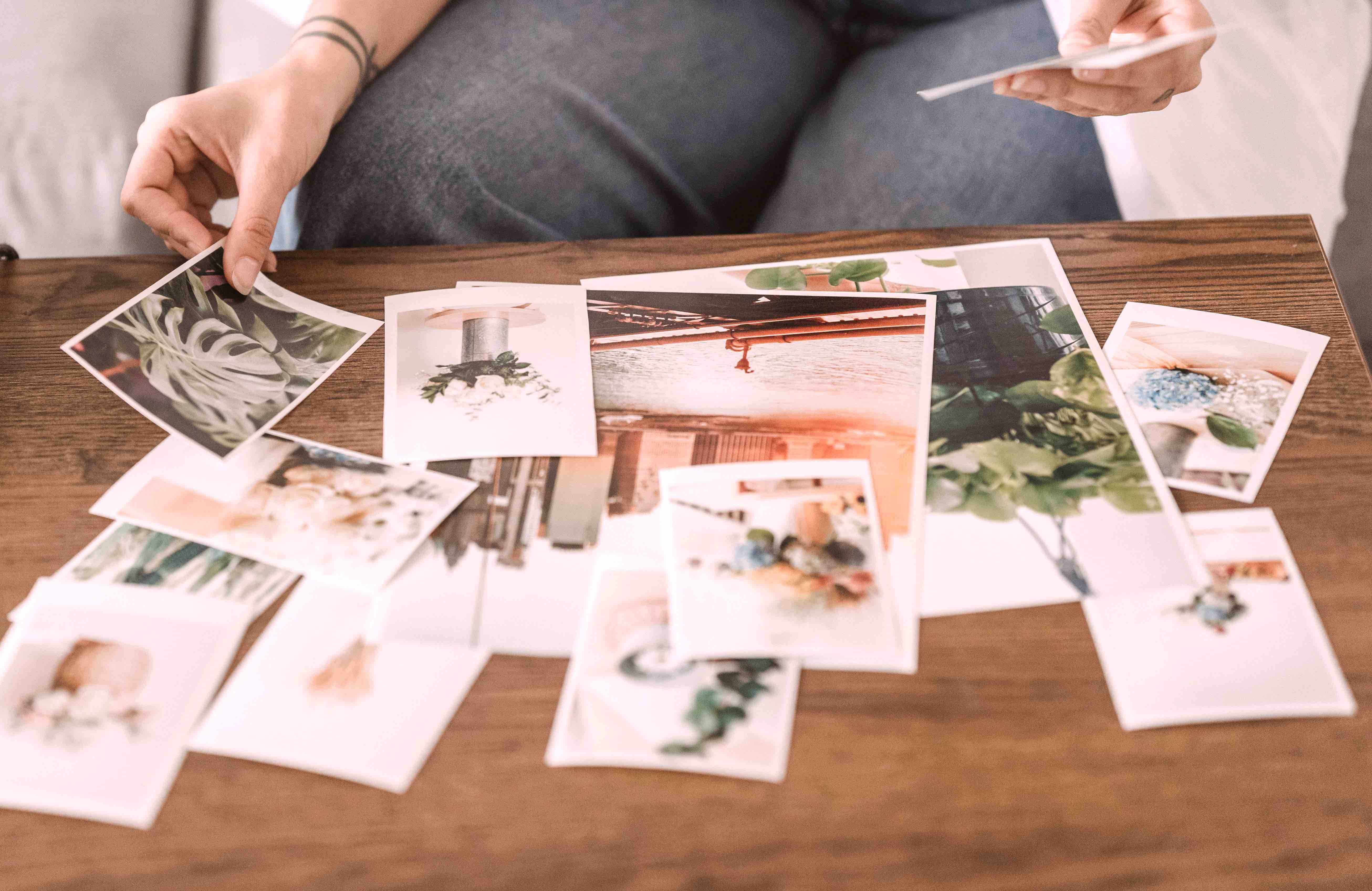Curated photo prints laid out on a wooden table